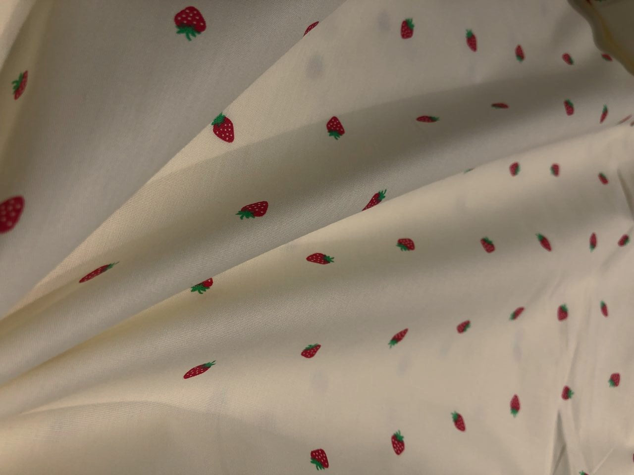 100% Cotton Poplin 58" Ivory with small red strawberry motifs [17560]
