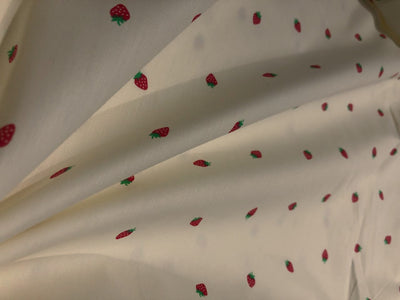 100% Cotton Poplin 58" Ivory with small red strawberry motifs [17560]